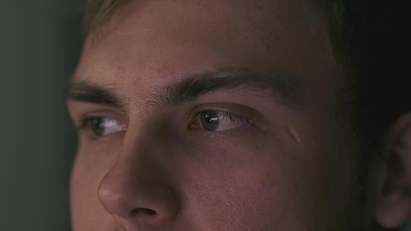 Close up of video game programming code on screen - Man looks at computer screen and wins. Clip. Man successfully ...