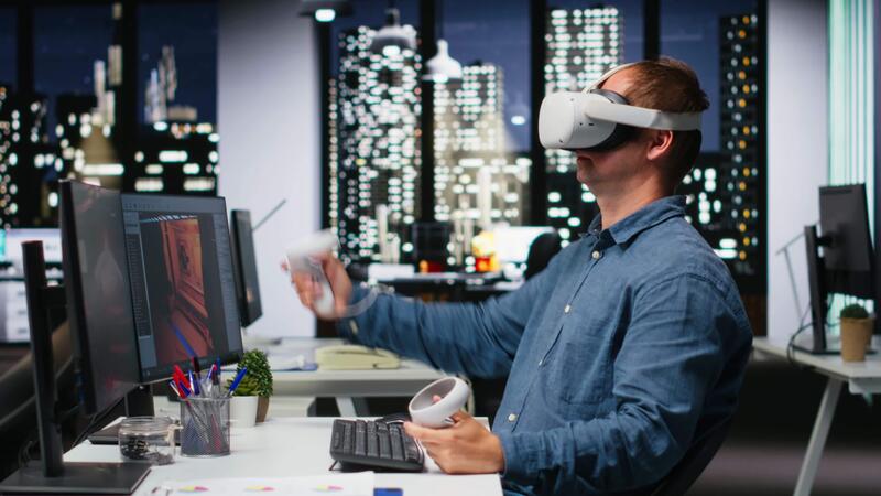 Game developer using AI software - Male game developer using VR glasses and AI tech to design a ...